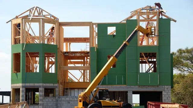 Builders framing the walls of a new house