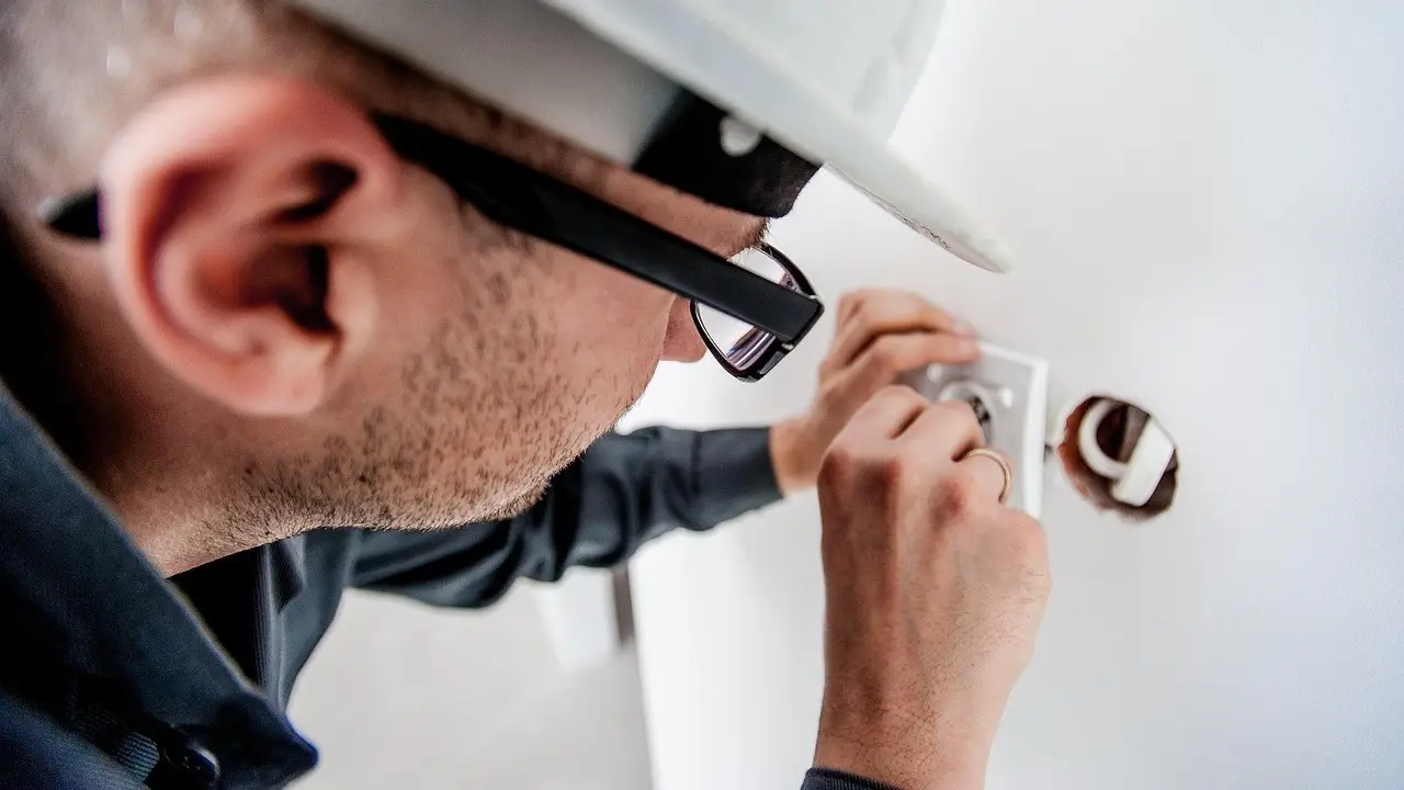 Electrician installing a wall outlet