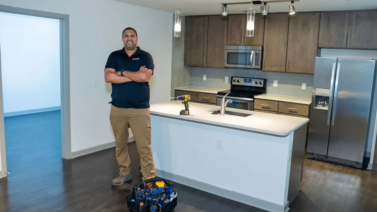 A contractor standing in a finished kitchen