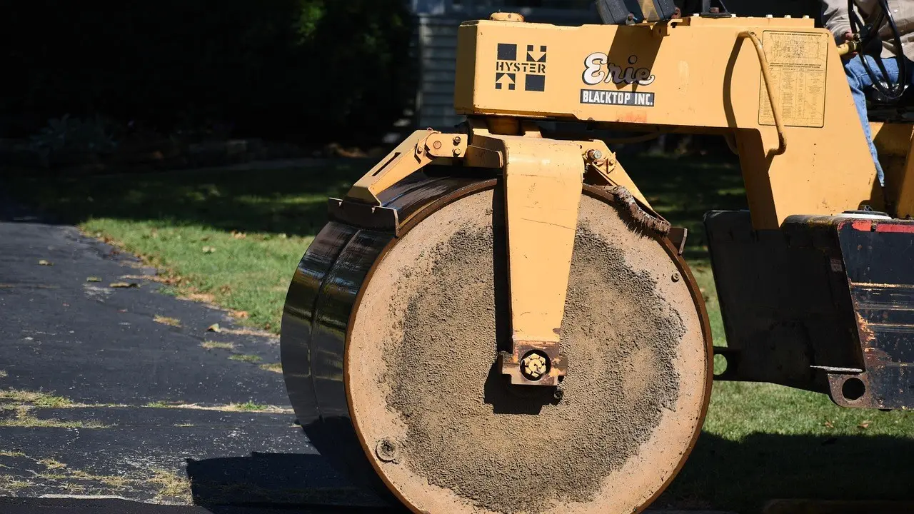A road roller pressing fresh asphalt