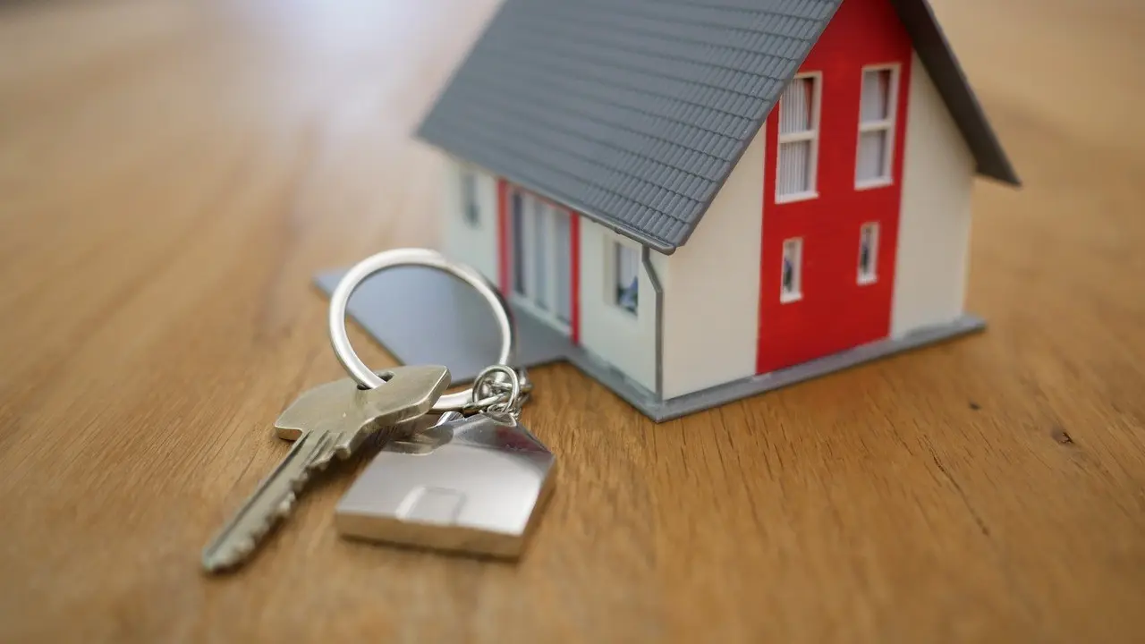 A model house and a set of keys on a table