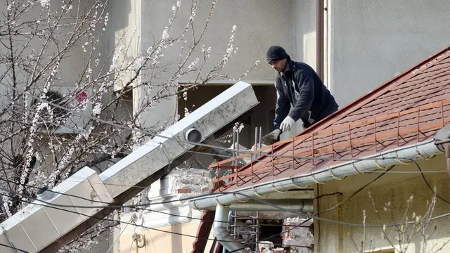 Roofer working on a sloped roof
